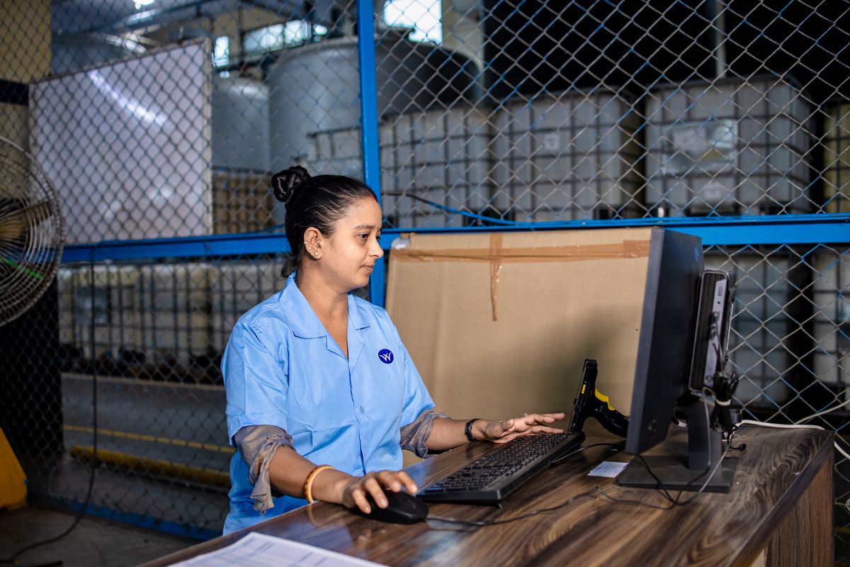 A dispatcher at her screen in a logistics office
