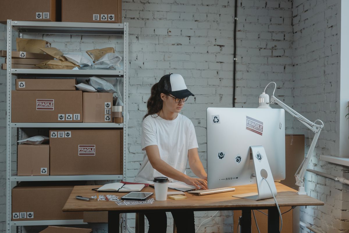 A dispatcher working at a desk in a logistics office